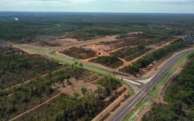 Alt text: Aerial view of Middle Arm Precinct showing road network, site access and early-stage development works 